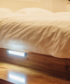 The LED light under a bed, illuminating the floor