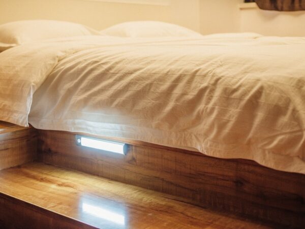 The LED light under a bed, illuminating the floor