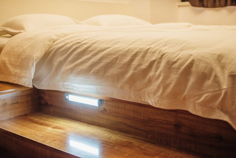 The LED light under a bed, illuminating the floor