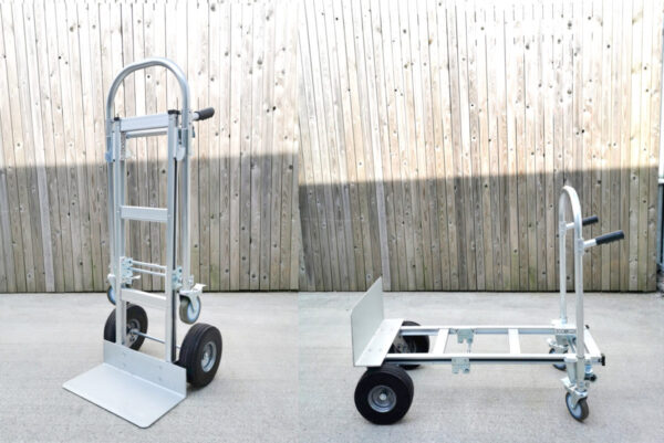 The 2 in 1 trolley seen in both it's positions. On the left it stands as a hand trolley on the right it sits as a flatbed trolley. It's silver and slightly matted with black wheels and handles.