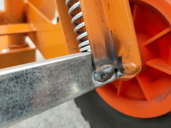 The weld on the back of the orange hand truck
