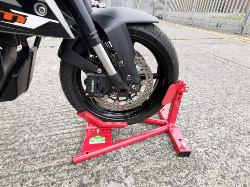 A close up of the motorbike stand in use. A motorbike wheel is raised and locked in place