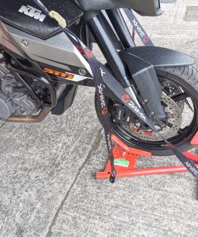 A side view of the bike in the sheds direct ireland motorbike stand. The straps are in use in the side ports, allowing the bike to freestand without assistance