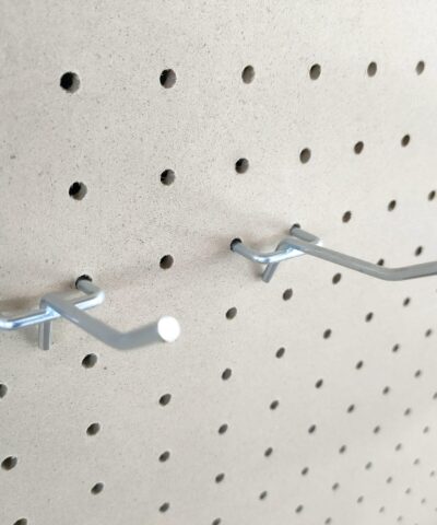 Two shiny grey tool hooks protruding from the pale wooden backboard of the sheds direct ireland tool shelf