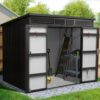 Premium Pitched Shed with the two doors fully open showing the light-grey interior, concrete floor, a workbench and a shovel inside.