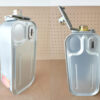 Spare tank inverter heater. Two of these tanks are stood side by side. They are long and rectangular in spare, but with smoothed corners. They are a light silver colour with a gold cap. There is a very feint rainbow tint to the gold cap. The one on the left is cloeed, however the one on the right has the cap open