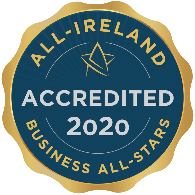 The All-Ireland Business All-Stars accreditation badge. It is a navy blue circular badge with gold trimming with an external frame like a pressed stamp. It reads 'ACCREDITED 2020' in grey text on the navy circle. 