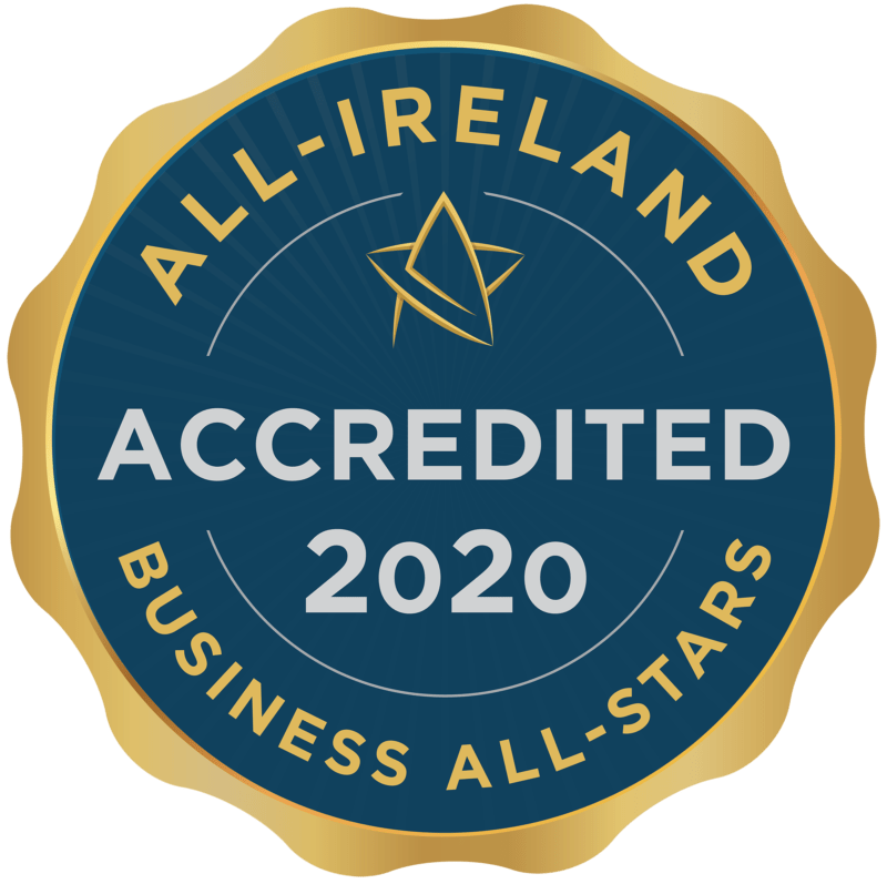 The All-Ireland Business All-Stars accreditation badge. It is a navy blue circular badge with gold trimming with an external frame like a pressed stamp. It reads 'ACCREDITED 2020' in grey text on the navy circle.