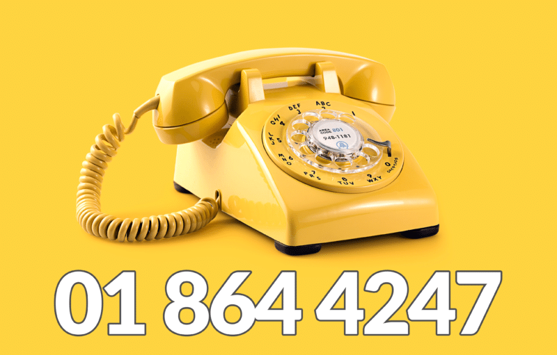 A yellow rotary phone against a yellow backdrop with the sheds direct ireland number, 01 864 4247, written on it. 