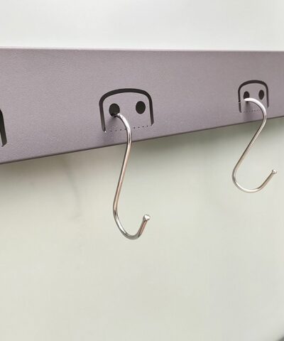 The built in tool hooks on the premium sheds. They are rounded rectangles with one end attached to the door. They have one or two large circular holes in the centre which can support tools. In the image 'S-hooks' are in position.