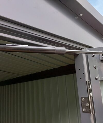 The gas-hinge on the door of the premium apex shed. It's above the door and connected to the nearest part of the door connected