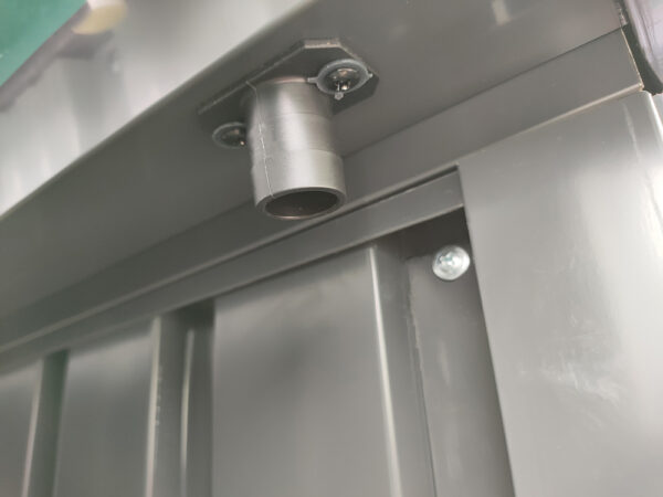 The outlet spout on the premium apex shed. It's a pale grey and one complete unit connected to the gutters