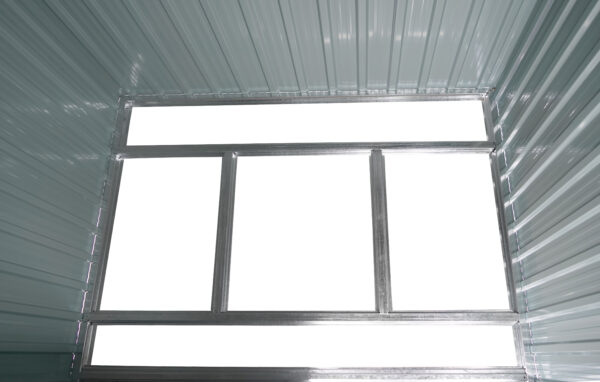 An inside view of the base of the tiny shed's frame base. It's made of 4 bars, 2 long horizontal ones which connect to both ends of the shed, and two smaller vertical bars which connect to the two horizontal bars.