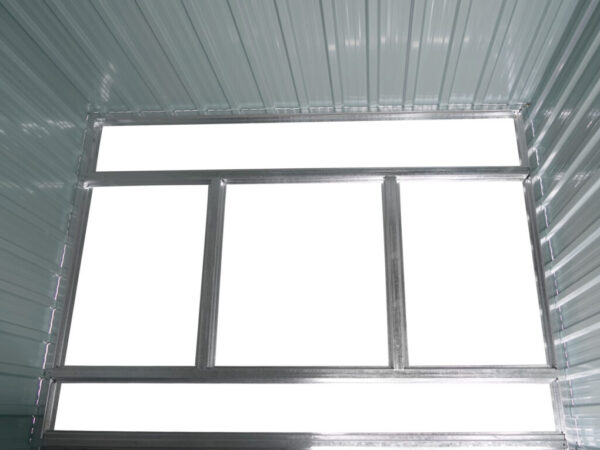 An inside view of the base of the tiny shed's frame base. It's made of 4 bars, 2 long horizontal ones which connect to both ends of the shed, and two smaller vertical bars which connect to the two horizontal bars.