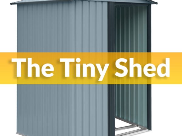 The Tiny Shed in grey against a white backdrop. It is a pale shade of grey with a darker grey trim. There is a one sliding door which is open. It reads 'THE TINY SHED' on top.