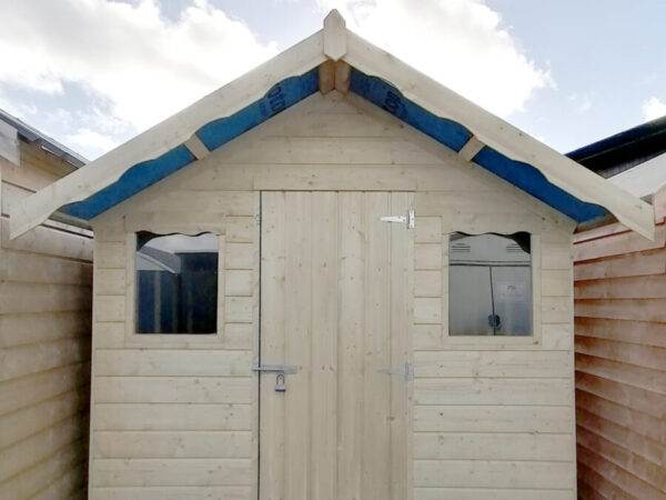 An exterior view of the Overhang wooden shed as seen in. aportrait orientation with lots of blue sky above the shed