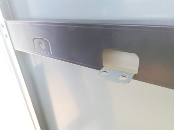 The built in tool hooks on the premium garden shed. They are metal bars into which soft-edged rectangles are perforated. They fold down to offer vertical tool hooks. One is till in position to show that they can be used either way
