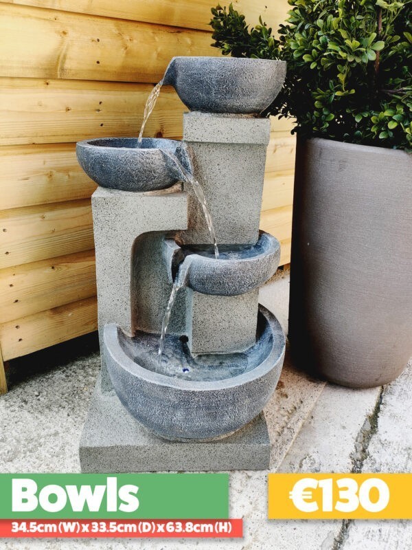 The Bowls Water Feature against a wooden shed