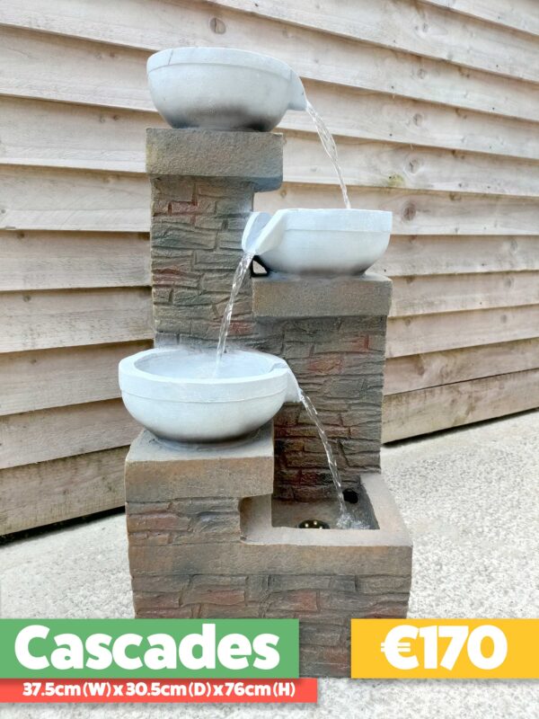 The Cascades Water Feature against a wooden shed