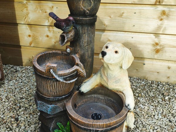 The Paws for Thought Water Feature. There is a dog and a bird on it and the water flows between them.