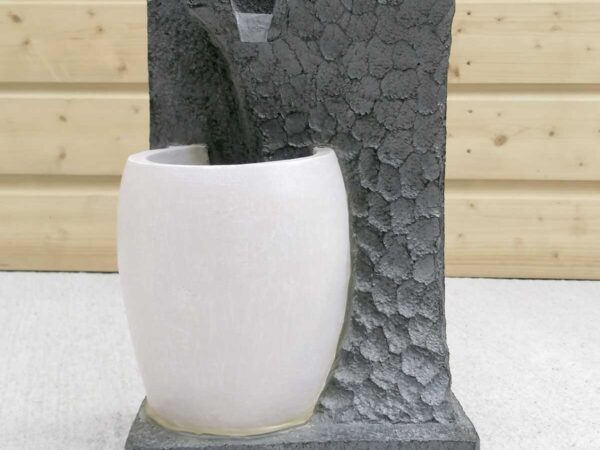 The grey and white single pot water feature with water flowing out the middle of it