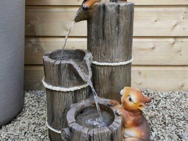 The Squirrels Water feature has two squirrels on it and they are standing on the pots and the water flows between them