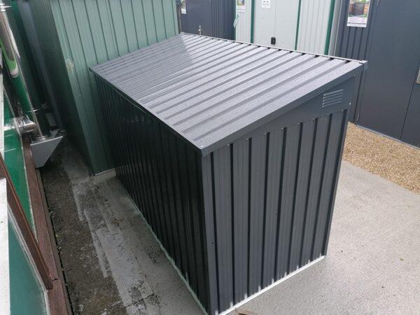 The bin store as seen from behind. The lid is reflecting the sun above so it is brighter in appearance than the rest of the unit