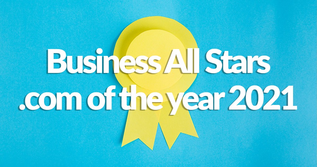 A yellow ribbon against a bright blue cloth backdrop. The ribbon reads 'Business All Stars .com of the year 2021'