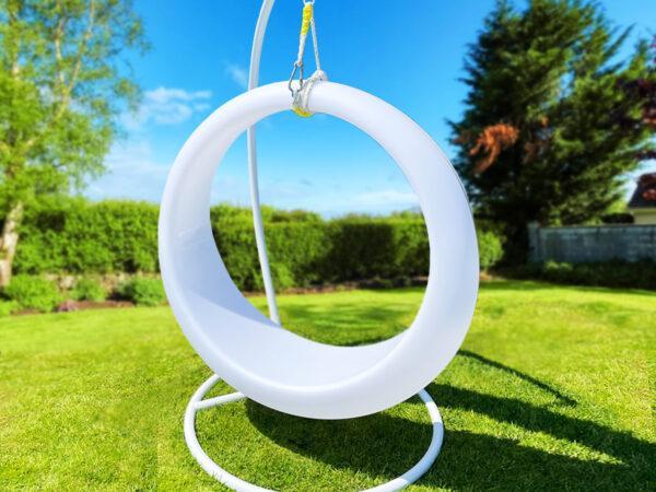 A LED Swing sitting on grass blue sky