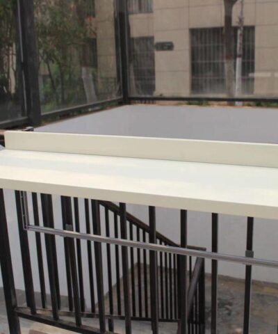 The XL white balcony table on a stairwell railing in the upright position.