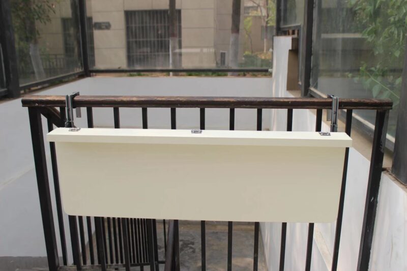 The White balcony railing table in the down position