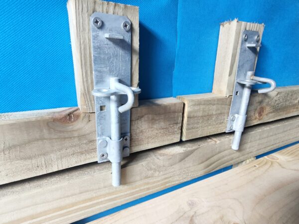 The internal locks on the garden bar - they are two bolt locks made of silver. They are facing downwards