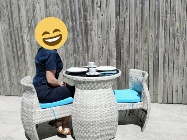 a woman sitting at the table and chairs set waiting for her food