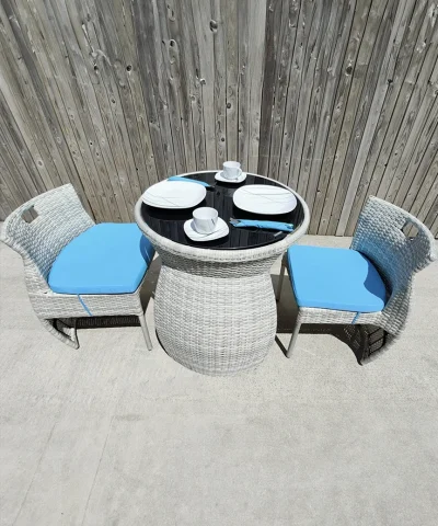 The bistro set with both chairs pulled out