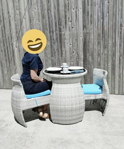 a woman sitting at the bistro set enjoying a cup of tea