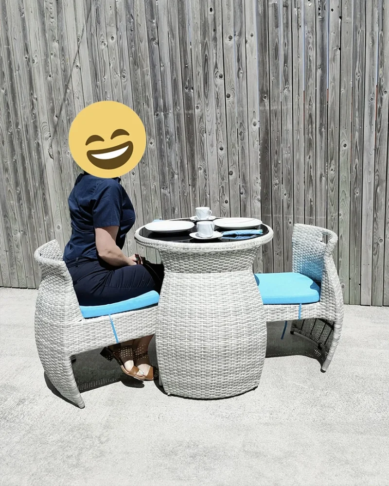 a woman sitting at the bistro set enjoying a cup of tea