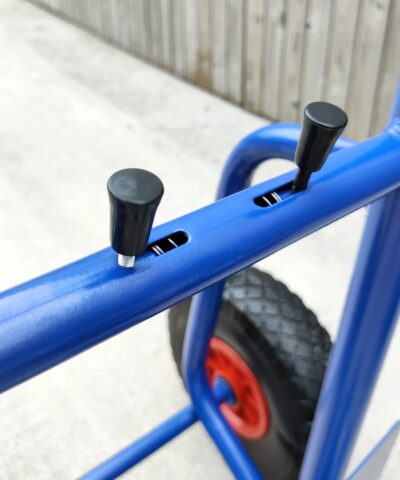 The compressible controls of the blue hand trolley which allow the movement of the back plate