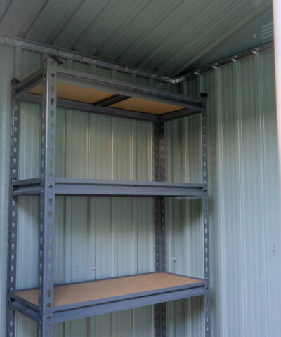 Shelves inside a steel shed. There are 5 tiers and the tiers have wooden bases.