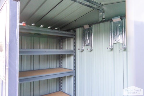 Shelves inside a steel shed. There are 5 tiers and the tiers have wooden bases.