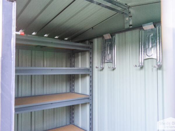 Shelves inside a steel shed. There are 5 tiers and the tiers have wooden bases.