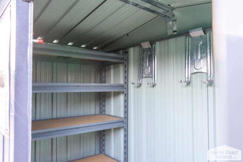 Shelves inside a steel shed. There are 5 tiers and the tiers have wooden bases.