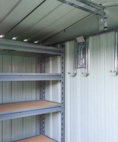 Shelves inside a steel shed. There are 5 tiers and the tiers have wooden bases.