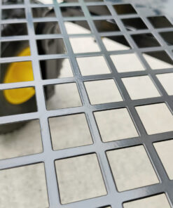 The detail of the mesh at the bottom of the mesh cart. It is a semi-matte painted black steel and the wheels are visible through the mesh.