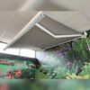 The awning fully extended over a grassy scene