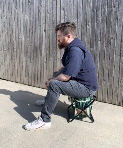 Sean from Sheds Direct Ireland sitting on the chair from the garden tool bag with chair set