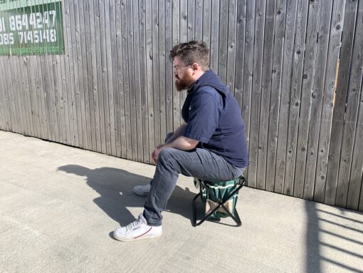 Sean from Sheds Direct Ireland sitting on the chair from the garden tool bag with chair set