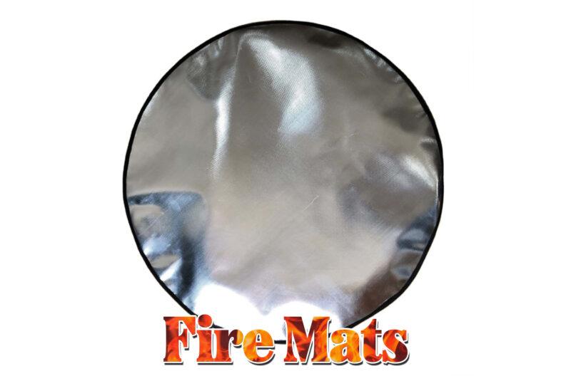 Fire Mats for Firepits - A picture of a large, circular, shiny firemat against a white backdrop. It has a black lined edge and great addition for fire pit safety.