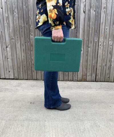 Woman holding the garden tool box by the handle