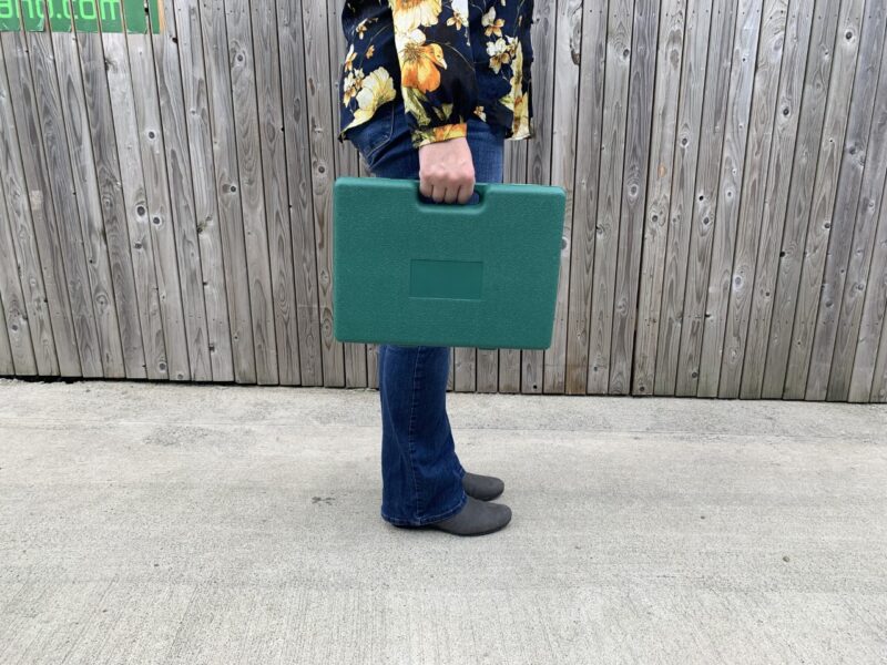Woman holding the garden tool box by the handle