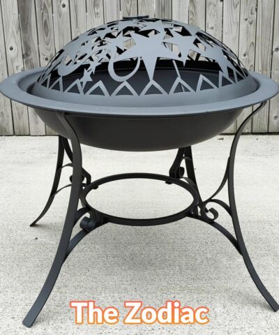 The Zodiac Fire Pit seen face on. It has a star motif on the top, to create interesting shadows. The legs are thin an elegant with a flower deign on them and the fire pit itself is flying-saucer shaped